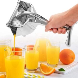 Stainless steel handheld fruit juicer squeezing a fresh lemon slice over a glass