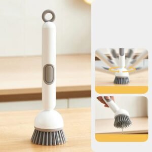 Adjustable kitchen cleaning brush with built in soap dispenser washing a frying pan