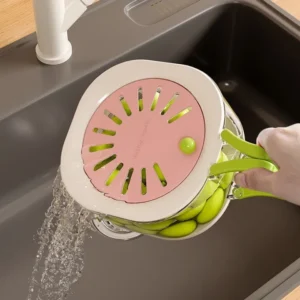 Multi-functional vegetable and fruit cleaning basket draining fresh produce in a sink