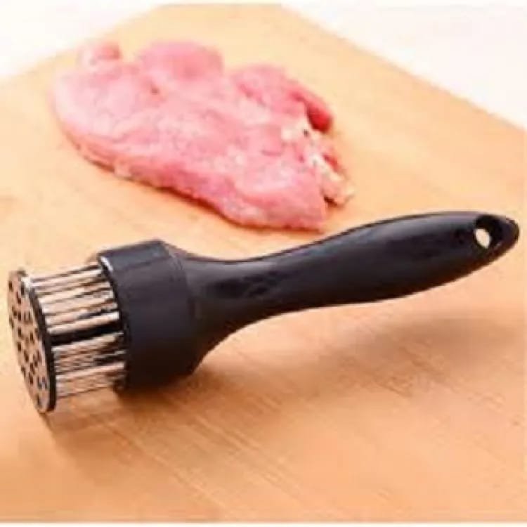 Stainless steel needle meat tenderizer being pressed into a fresh raw beef steak