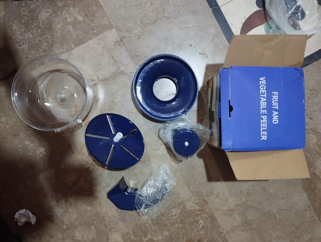 Automatic electric fruit and vegetable peeler peeling an apple on a kitchen counter